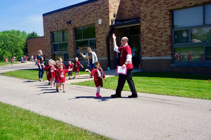 <p>Here’s Louise White Principal Dr. Kevin Skomer teaching students how to do the royal wave.</p>
